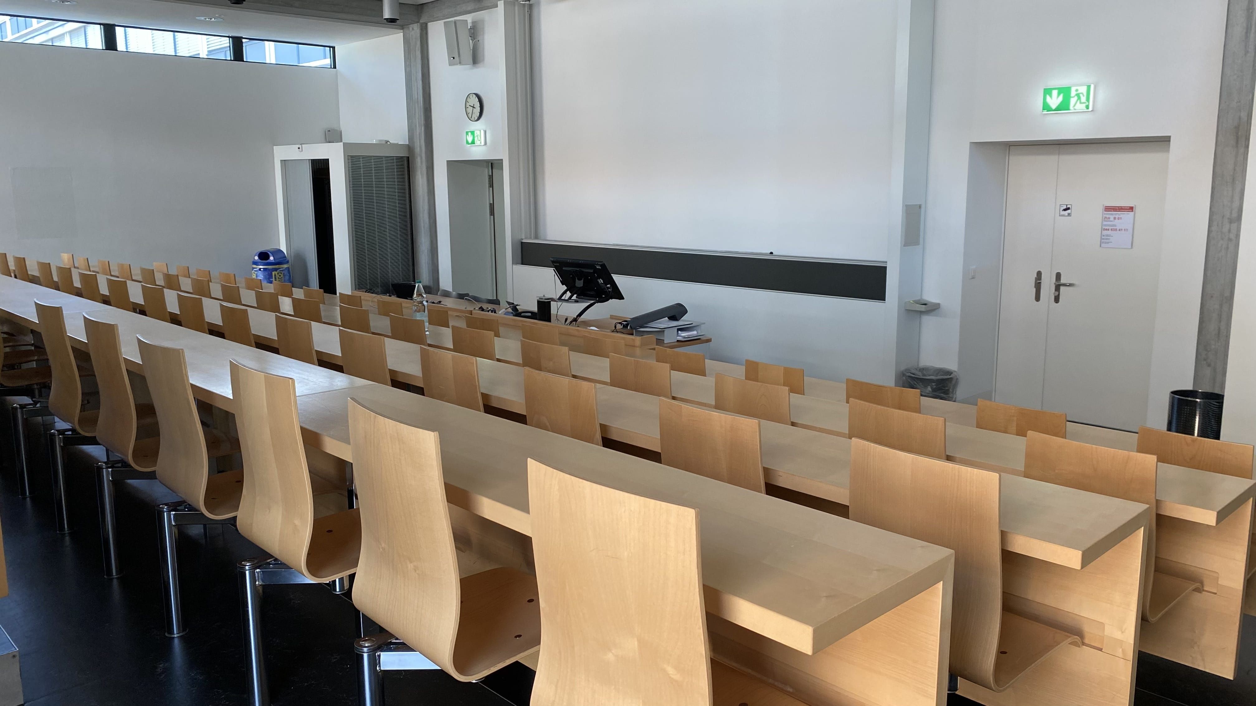 Hörsaal ZUI-B-1: Ansicht zum Dozierendenpult hin. Links und rechts befinden sich Eingangstüren.